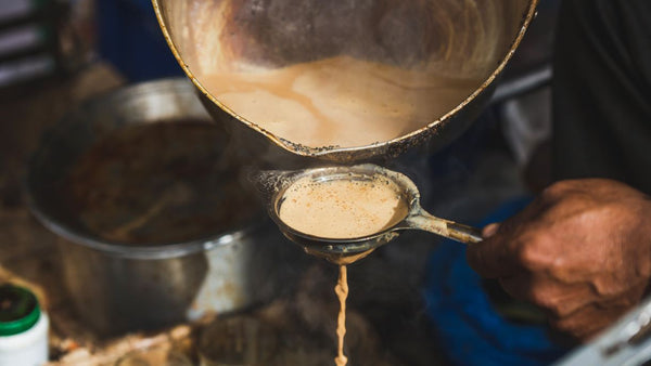 A vendor makes traditional chai on the streets of Kolkata, India.